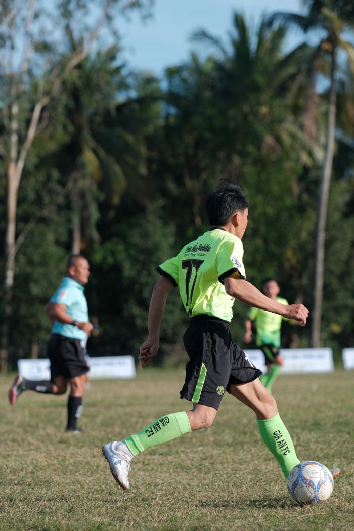 Dynamic soccer scene with players in action on a sunny day.